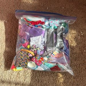 Bag of Barbie clothes and shoes
